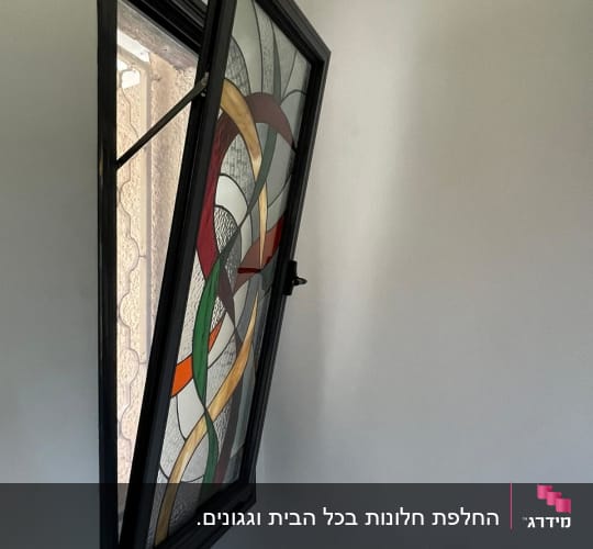 חלון אלומיניום עם זכוכית צבעונית פתוח חלקית
